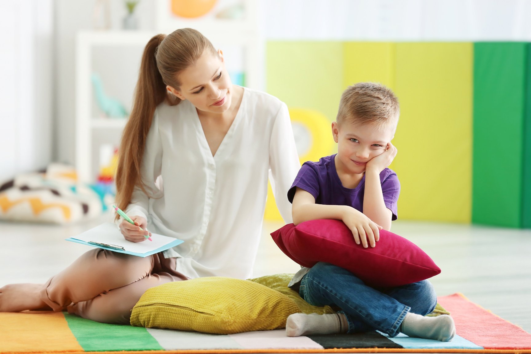 Young Female Psychologist Working with a Little Boy Indoors