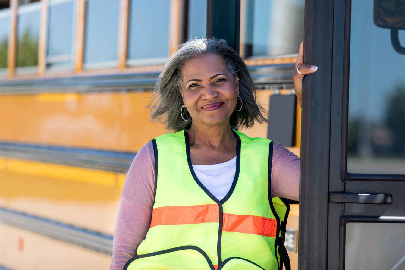 Confident African American school bus driver