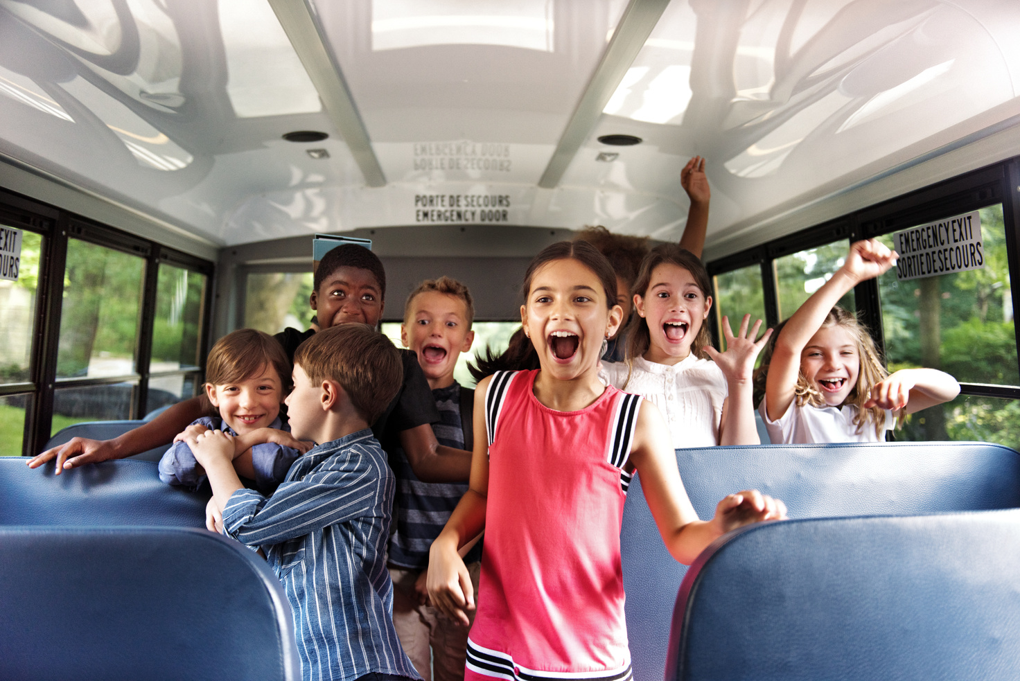 School kids gesturing on school bus