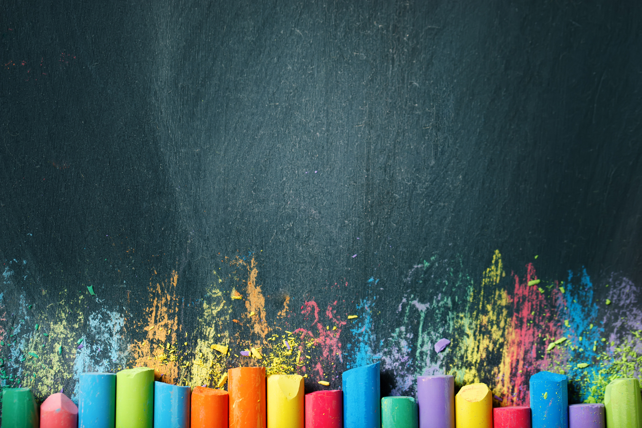 Colorful crayons on the blackboard, drawing. Back to school background