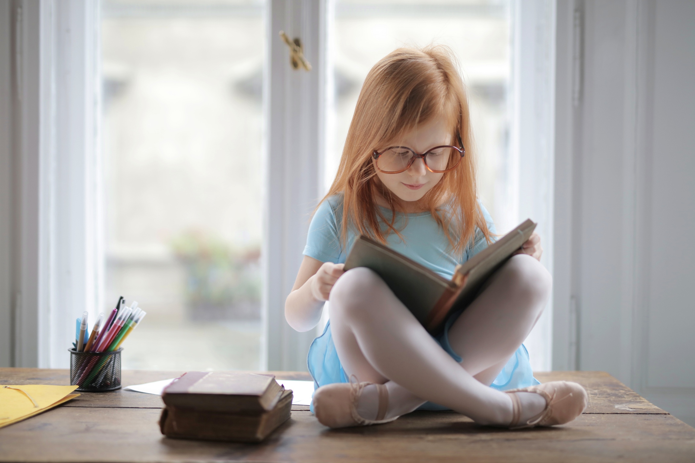 Girl In Blue Shirt Reading A Book