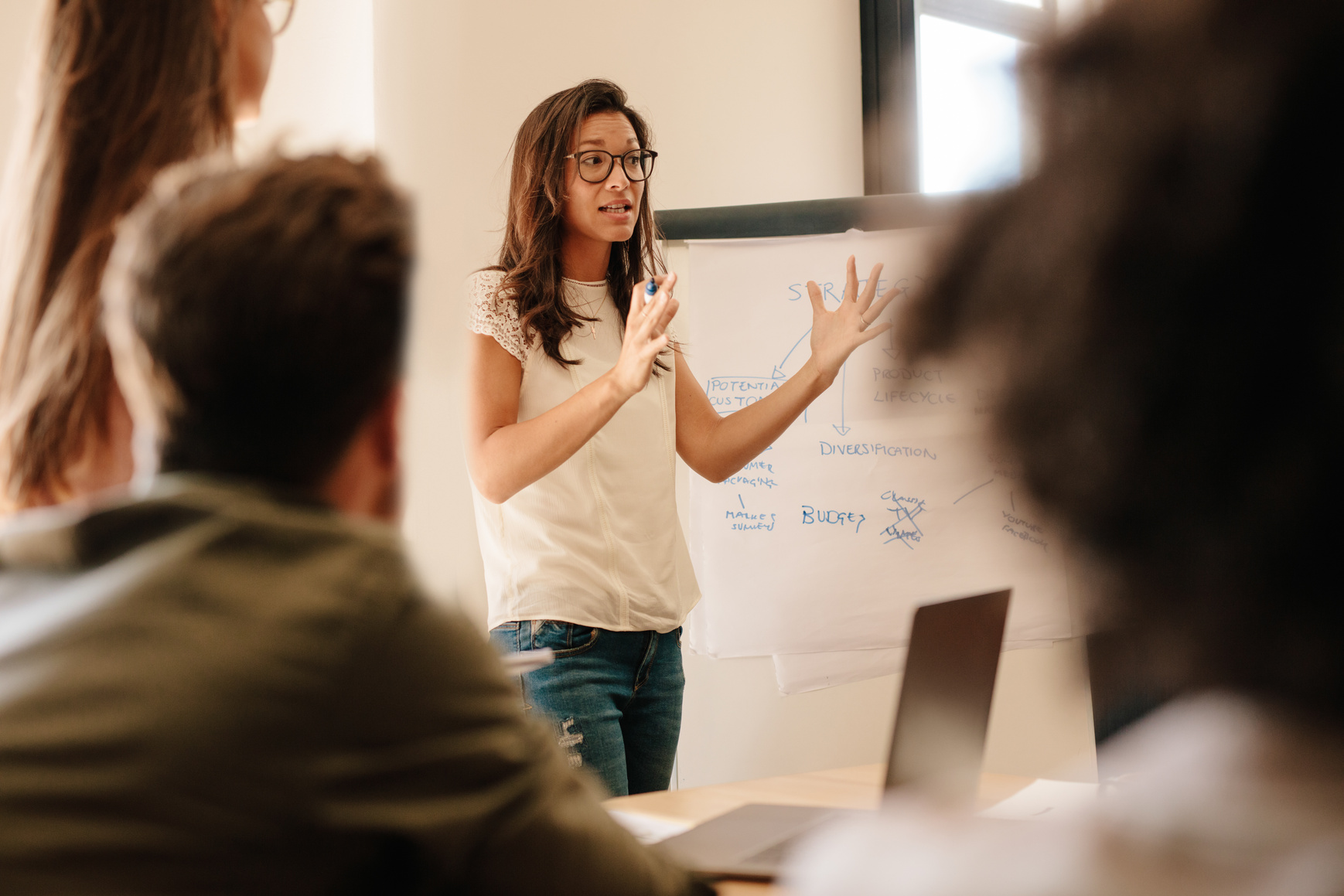 Woman Explaining in Front of Coworkers 