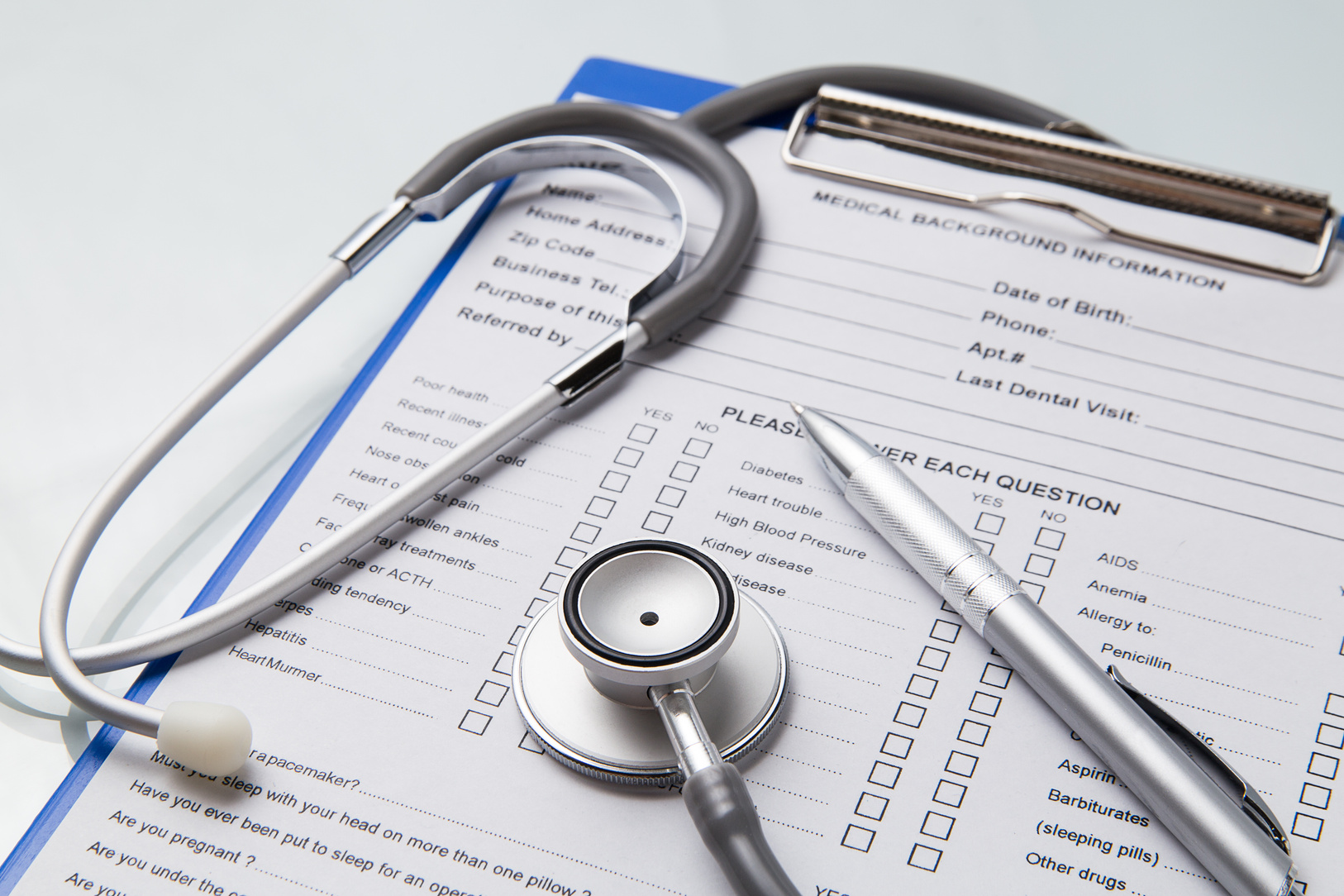 Stethoscope and Pen Over Medical Document