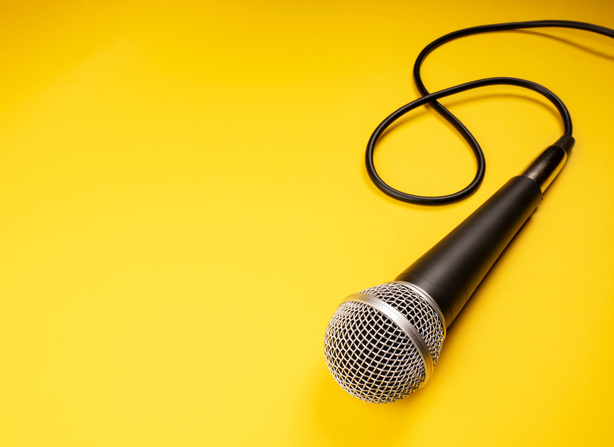 Microphone on yellow background