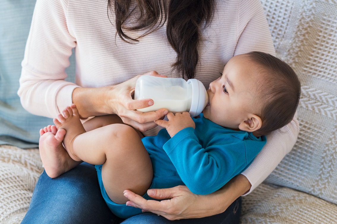 Infant Drinking Milk on Her Mother's Arms