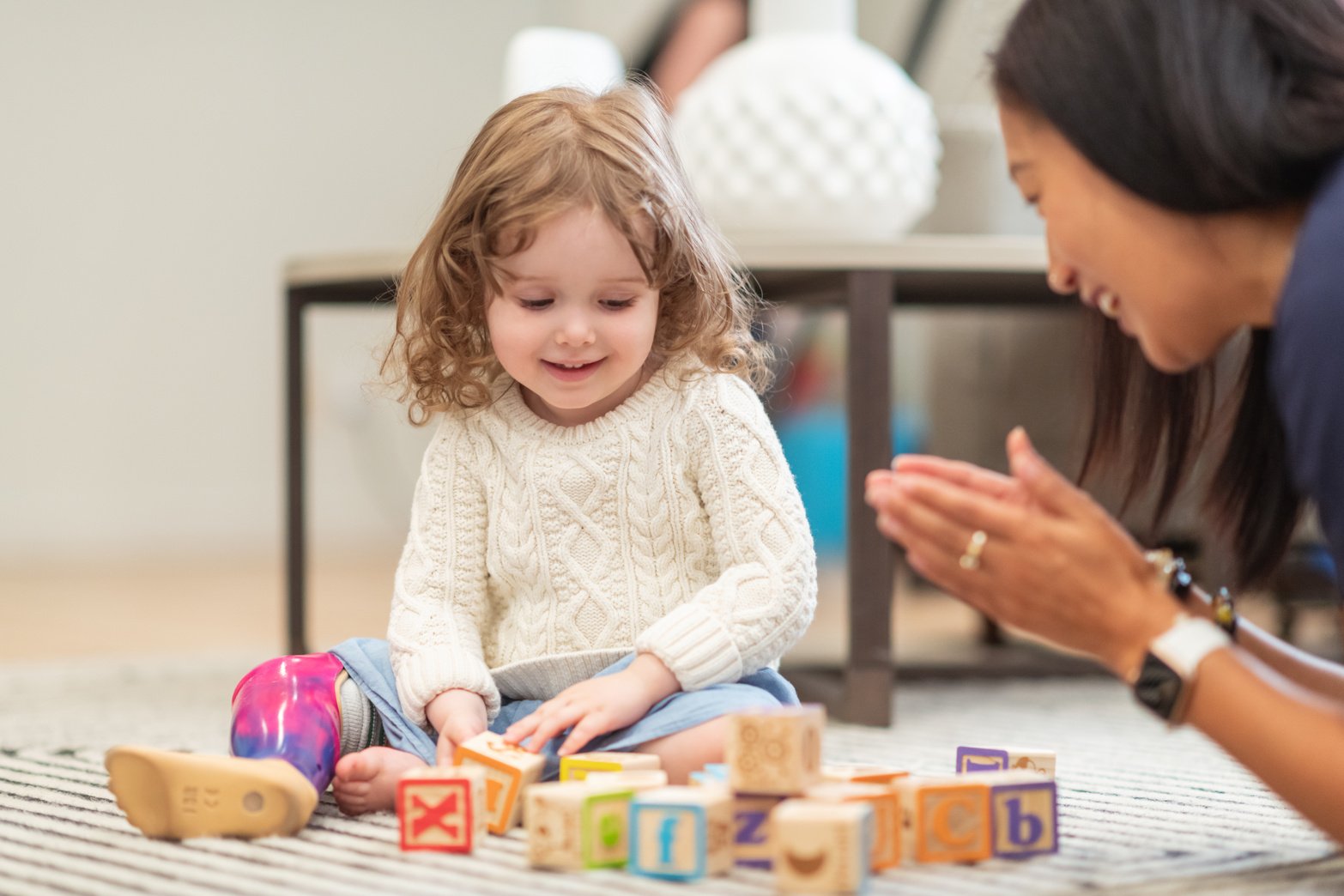 Little girl with prosthetic leg at occupational therapy appointment