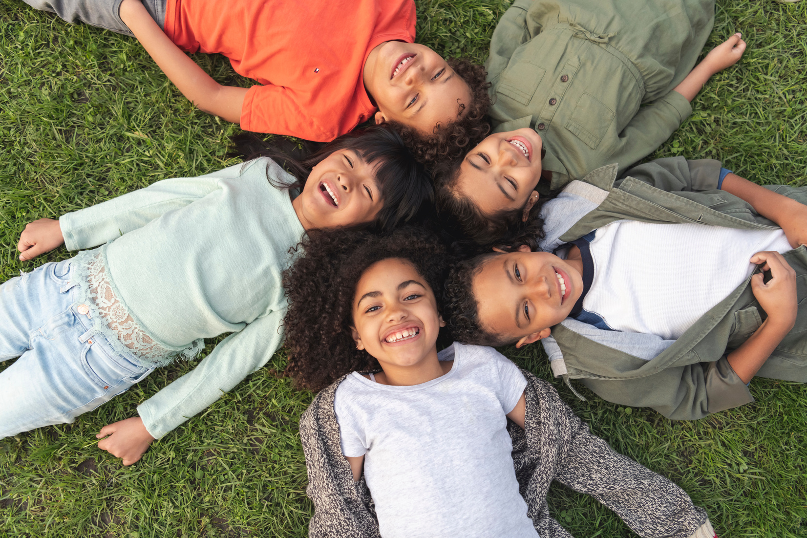 Kids laying on grass